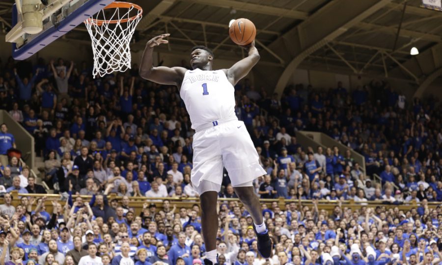 Forward Zion Williamson of Duke University (1) rises up for a slam dunk. 