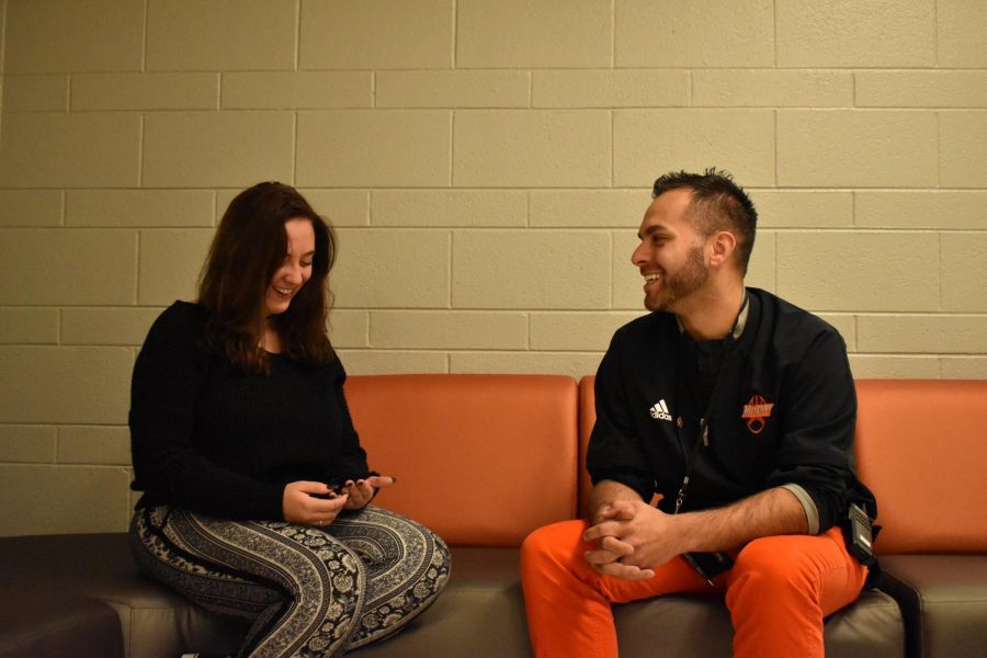 Justin Stroh smiles as he converses with senior Stacy Correra outside of the classroom. One of Strohs main goals as dean is to establish a more positive relationship with students across both campuses. 