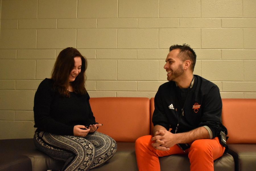 Justin Stroh smiles as he converses with senior Stacy Correra outside of the classroom. One of Stroh's main goals as dean is to establish a more positive relationship with students across both campuses. 