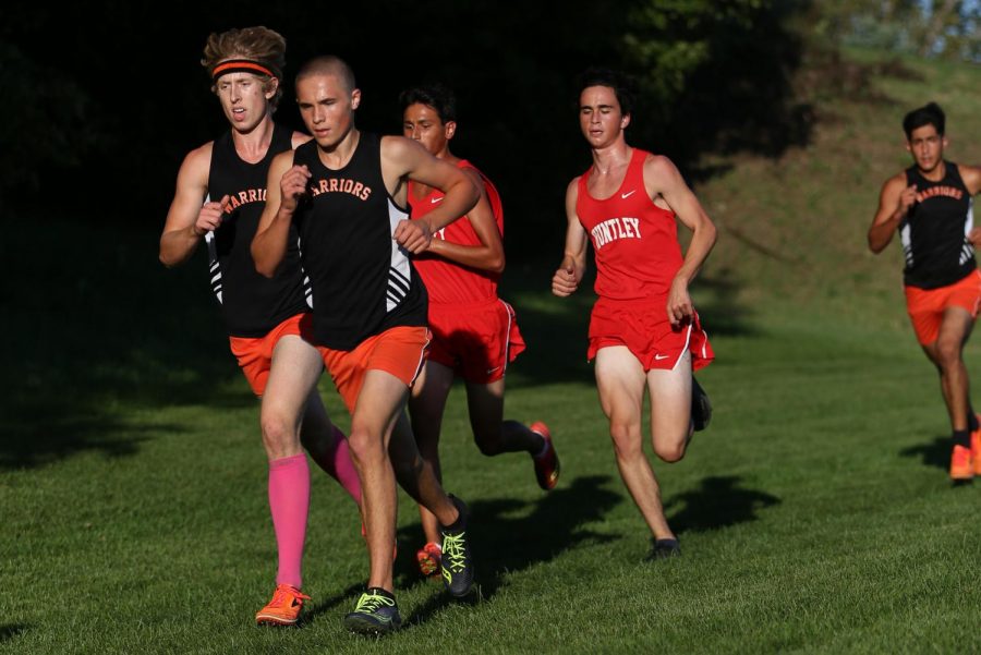 Junior+Caleb+Schopen+and+Seniors+Ian+Knebl+push+ahead+of+their+Huntley+opponents+during+a+cross-country+meet+on+September+24+at+McHenry+Township+Park.