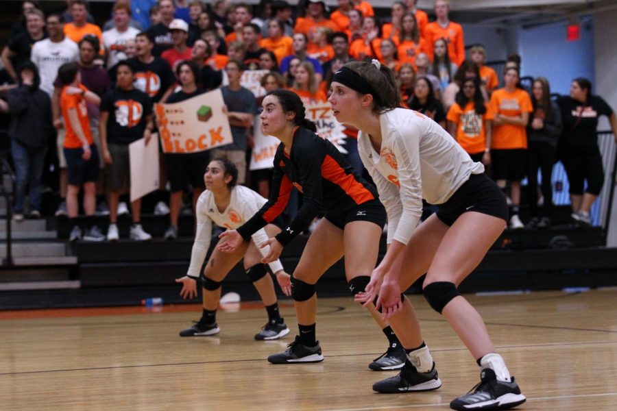 Senior setter Taylor Zoephel gets into a ready position with juniors Andrea Barajas and Savannah Coats during varsity volleyball game against Hampshire on August 27.