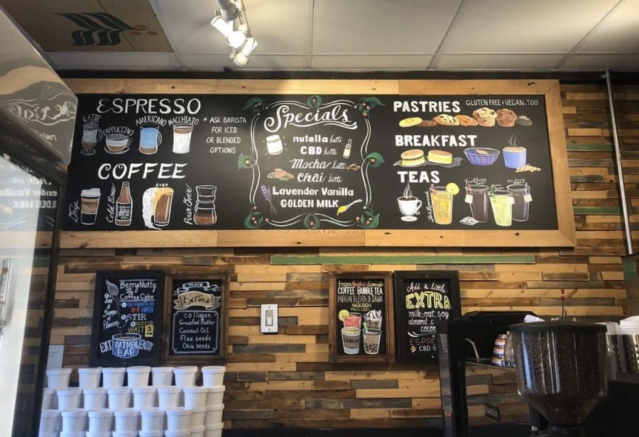 The counter at Grounds Cafe in Crystal Lake displays the variety of food and drinks they serve, including Nutella lattes, bubble tea, and vegan pastries.