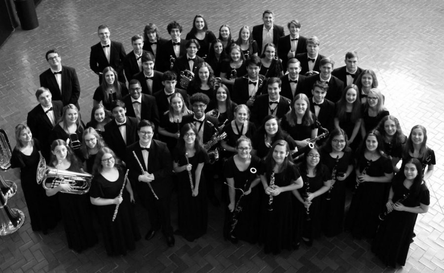 The symphonic band pose prior to their performance at the Illinois Music Education Conference in Peoria on February 1. The band was one of only 16 high school bands in the country selected to perform at National Concert Band Festival in Indianapolis this weekend before the trip was cancelled.