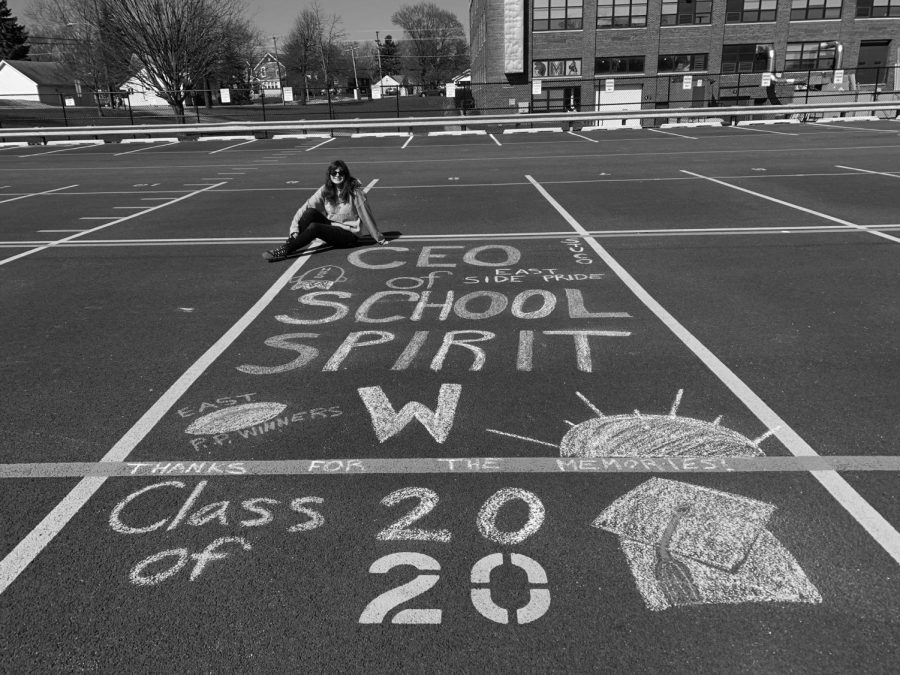 Waiting to hear the verdict on the rest of her senior year, Senior Gracee Majkrzak draws on her East Campus parking spot.