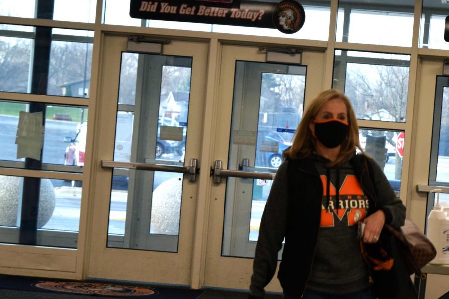 CTE division chair Karyn Burmeister walks into West Campus wearing a mask on November 20. As cases in McHenry County rise, staff rely on clear information to decide whether to work from their classroom or from home.