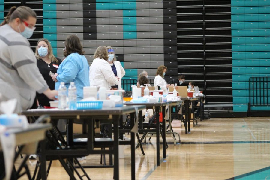 Nurses reset injection stations set up at Woodstock North High School on February 12 after a wave of MCHS teachers, staff members, and administrators received their first dose of the COVID-19 vaccine.