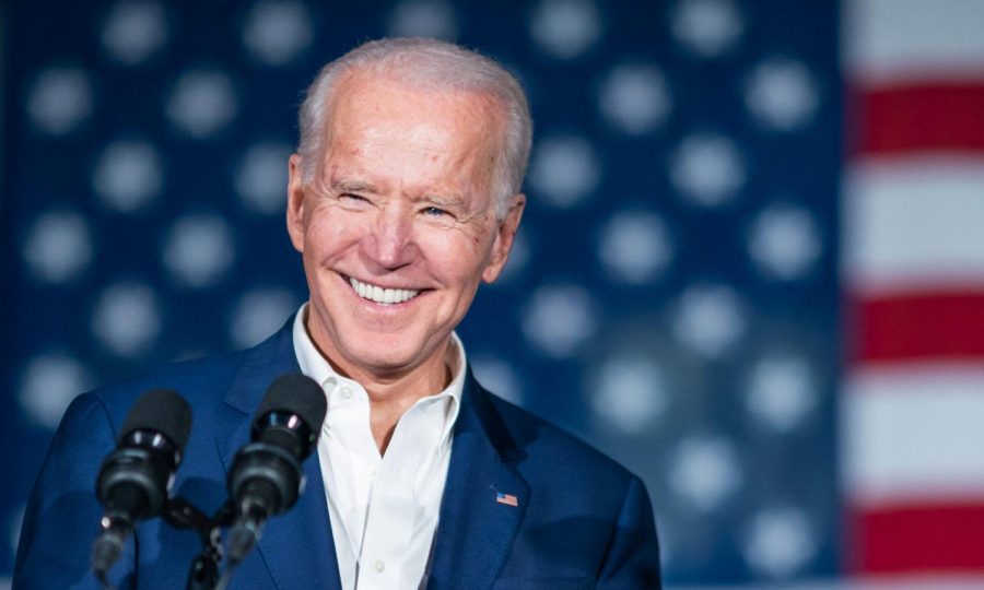 President+Biden+speaks+at+an+event+in+Jackson%2C+MS+standing+in+front+of+an+American+flag.+During+his+first+hours+in+office%2C+President+Biden+has+already+made+progress+toward+fulfilling+his+100-day+agenda.