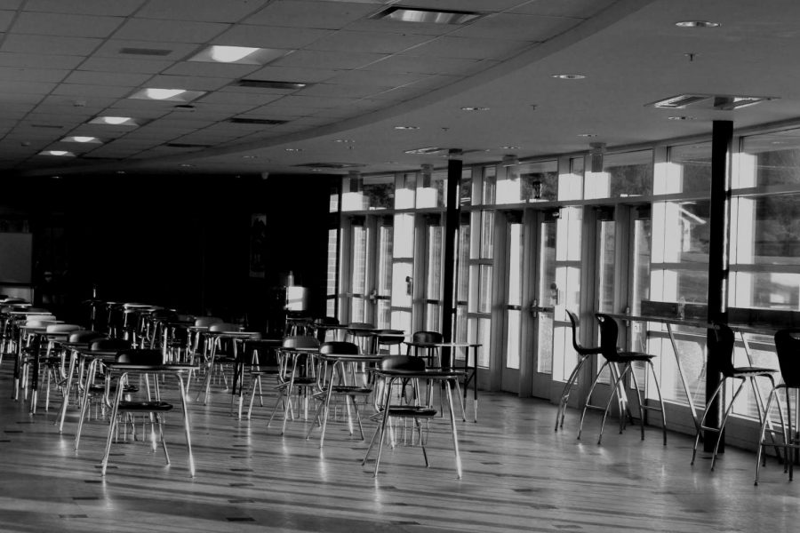 Empty, socially distant desks wait in the West Campus south foyer for students to sit and eat their lunches — one of many ways the past year felt different to students.