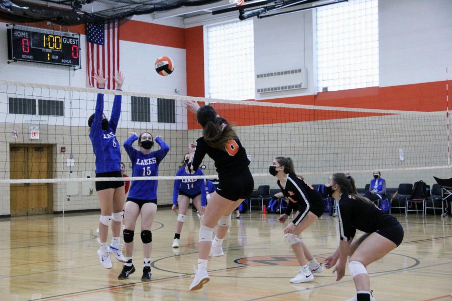 Regina Anelli spikes the volleyball during a home volleyball match on March 22 against Lakes High School.