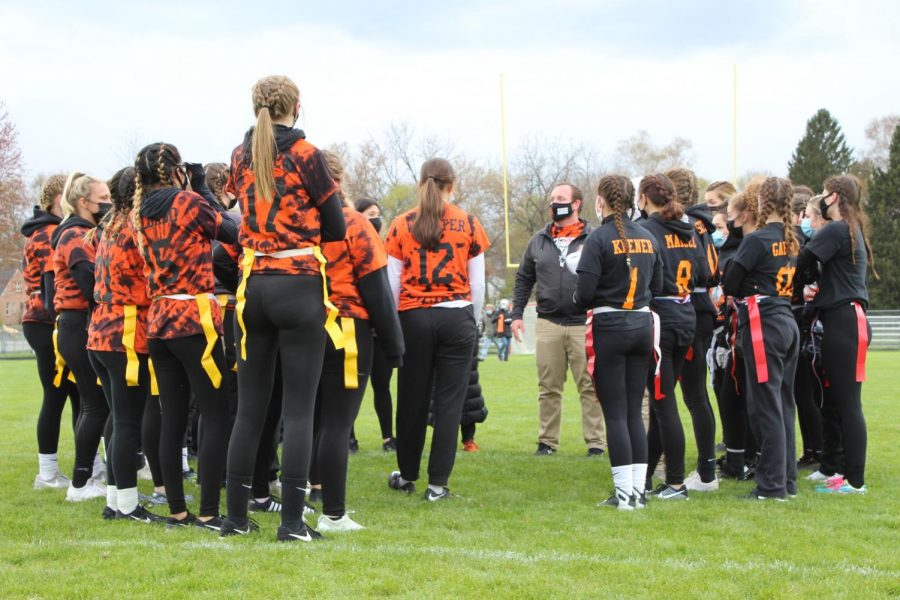 Spanish teacher Jordan Diener meets with both teams before the Powder Puff football game on April 20 at McCracken Field.