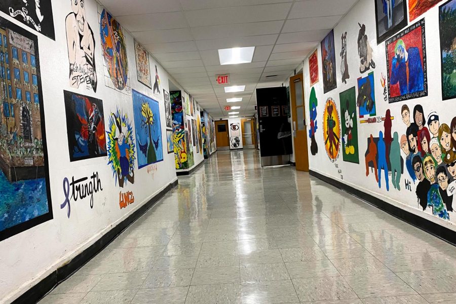 The art hallway at East Campus is currently decorated with murals painted by students across decades — a beloved tradition that has helped shape the identity of the campus.