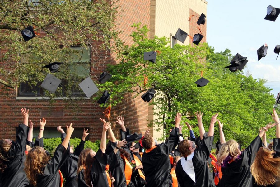 The Class of 2021 tosses their caps following their commencement ceremony on May 20 outside of East Campus. This was one of 14 separate graduation ceremonies held by East Campus.