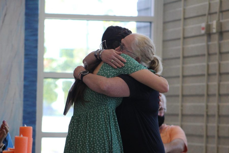 Senior Mackenzie Cutler and coach BJ Macdonald embrace during the girls swimming teams banquet following their senior night meet. 