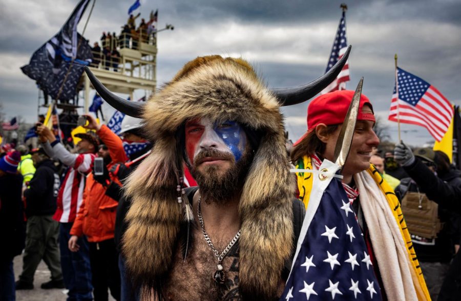 Jacob Anthony Angeli Chansley, known as the QAnon Shaman, amid the U.S. Capitol riot in Washington, D.C., on Jan. 6, 2021. Allen Hostetter claims he was manipulated into participating in the insurrection by the Yale secret society Skull and Bones. 