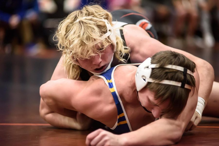 Senior Brody Hallin pins a wrestler during a match against Johnsburg on Nov. 23 in the Freshman Campus main gym. Hallin, along with junior Christopher Moore, have helped guide the team to a successful season.