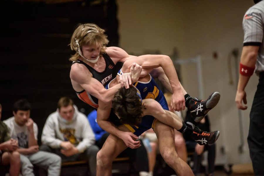 Rocky Piehl locks his opponent in a headlock during a match against Johnsburg on Nov. 23 in the Freshman Campus main gym.