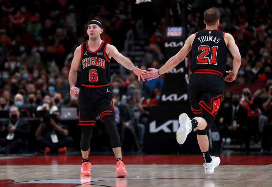 Chicago Bulls guards Alex Caruso (6) and Matt Thomas (21) celebrate after a basket by Thomas in the first half against the Cleveland Cavaliers at the United Center on Wednesday, Jan. 19, 2022.