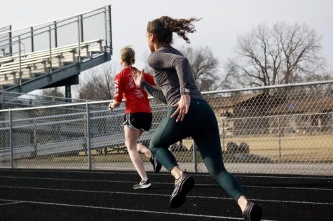 Girls track team members Ali Casey and Jennifer Orozco practice at the track at McCracken Field on Mar. 14 in preparation for their first meets of the season.