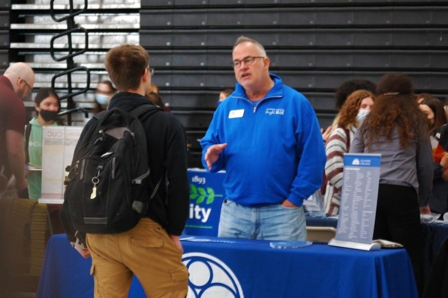 Students talk to representatives from various colleges and career paths during the College and Career Fair in the Upper Campus main gym on April 21.