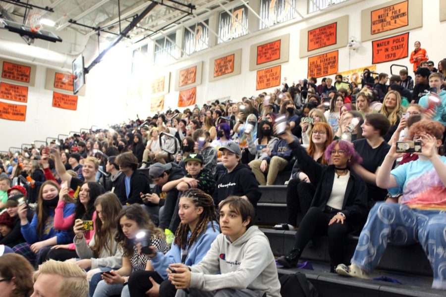 Students watch Staff Infection perform during a sneak peek at the Upper Campus on April 29 in the main gym.