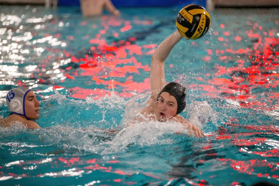A varsity water player polo looks to shoot the ball at his opponents goal during a match in the Upper Campus pool against Vernon Hills on April 20.