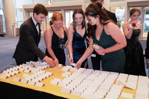 Students find their place cards during prom on April 29 at the Renaissance Convention Center in Schaumburg. 