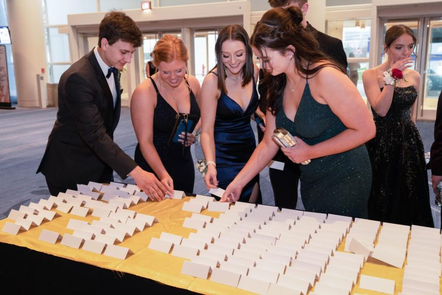 Students find their place cards during prom on April 29 at the Renaissance Convention Center in Schaumburg. 