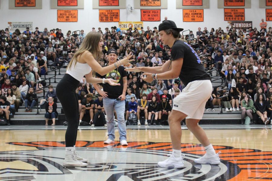 Students play rock-paper-scissors at a spirit rally at the Upper Campus on Aug. 18 in the main gym.