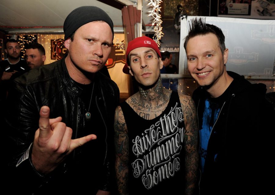 From left, musicians Tom DeLonge, Travis Barker and Mark Hoppus of Blink-182 pose at a press party in West Hollywood, California, in 2011. DeLonge is rejoining the band for a world tour next year.