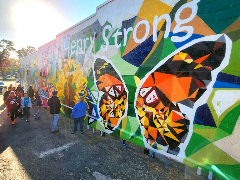 Community+members%2C+including+students+from+MCHS%2C+paint+a+mural+in+downtown+McHenry+on+Saturday%E2%80%94the+first+public+mural+in+the+towns+history.