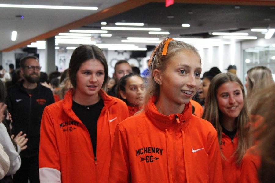 Members of the girls cross-country team march through the halls of the Upper Campus on Nov. 4 before departing for the IHSA State Cross Country Meet that weekend in Peoria. This was the first time in MCHS history that the whole team qualified for State.