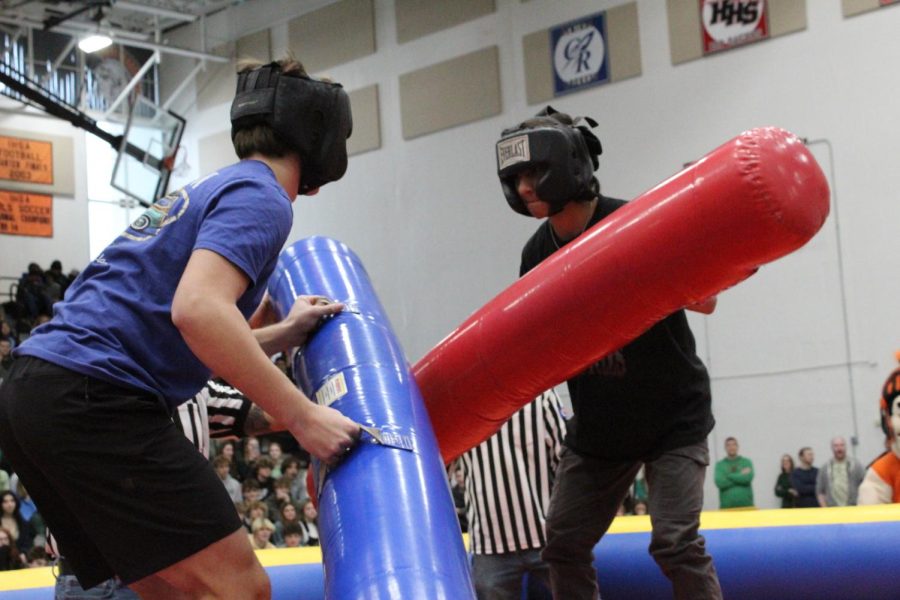 Students participate in a joust at the winter spirit rally on Dec. 16 in the Upper Campus main gym.