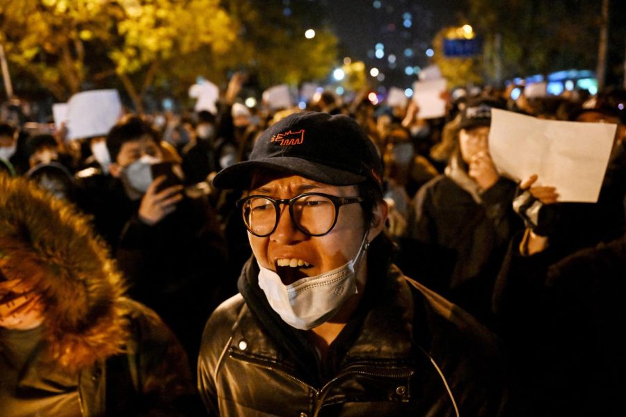 Protesters march along a street during a rally for the victims of a deadly fire as well as a protest against Chinas harsh COVID-19 restrictions in Beijing on Nov. 28, 2022.