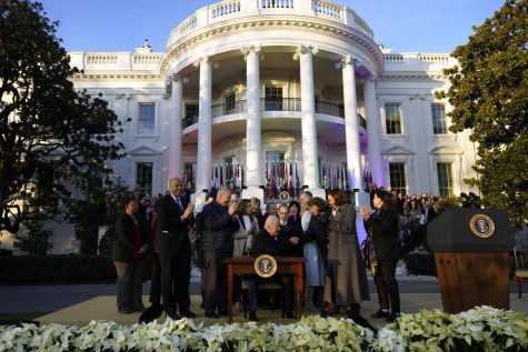 U.S. President Joe Biden signs the Respect for Marriage Act during a ceremony on the South Lawn of the White House in Washington, D.C., on Tuesday, Dec. 13, 2022.