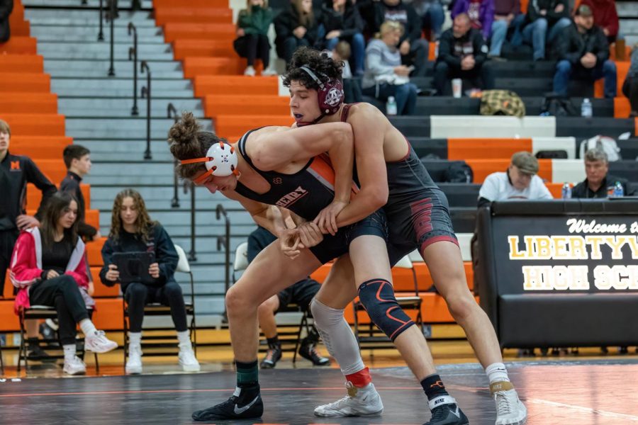 Nathaniel Wirch prepares to wrestle his opponent from Antioch during a varsity meet on Nov. 23 at Libertyville High School.