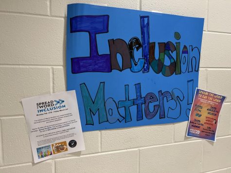 A handmade sign reads Inclusion Matters! hangs on the wall in Upper Campus.