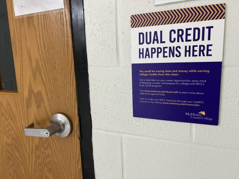 Signs hang outside of classrooms where dual credit classes take place at MCHS. Next year, students enrolled in dual credit classes will be charged $25 per class each semester.