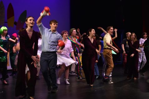 The cast of MCHSs SpongeBob: The Musical sing on stage during a rehearsal on March 6 in the Upper Campus Auditorium.
