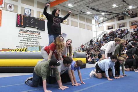 The sophomores celebrate a dizzy human pyramid contest during the spring spirit rally in the Upper Campus Main Gym on March 23.