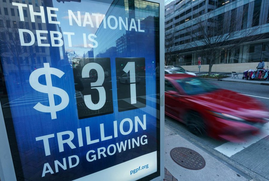 A+sign+at+a+bus+shelter+shows+the+national+debt+in+Washington%2C+DC+on+Jan.+20%2C+2023.+