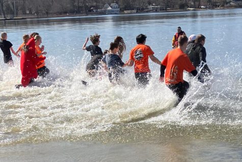 Students from MCHSs Key Club splash into the water at the Crystal Lake Beach on March 4 to raise money for Special Olympics.