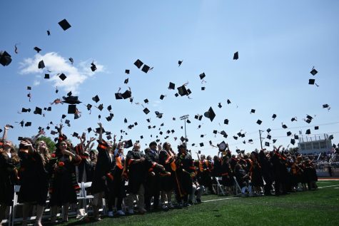The Class of 2023 throws their caps at the end of the graduation ceremony at McCracken Field on May 20 — the first combined graduation held on the newly-renovated football field.