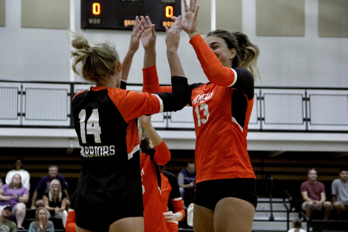 Players+celebrate+a+point+during+the+varsity+volleyball+match+against+Burlington+Central+on+Sept.+5.+