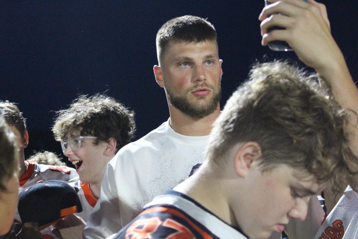 Chicago Bear and MCHS alum Robert Tonyan poses for pics on the sideline during the varsity football game against Huntley on Sept. 1 at McCracken Field.