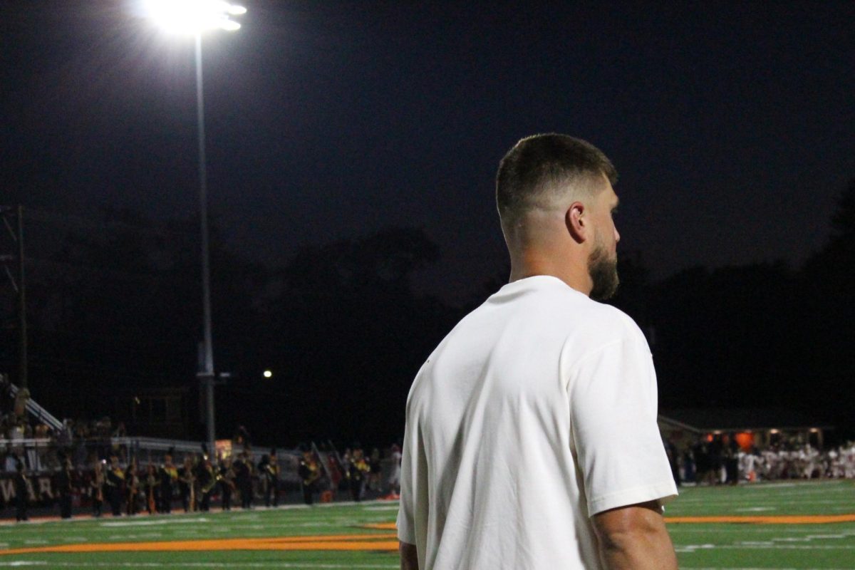 Chicago Bear and MCHS alum Robert Tonyan watches the varsity football game against Huntley on Sept. 1 at McCracken Field.
