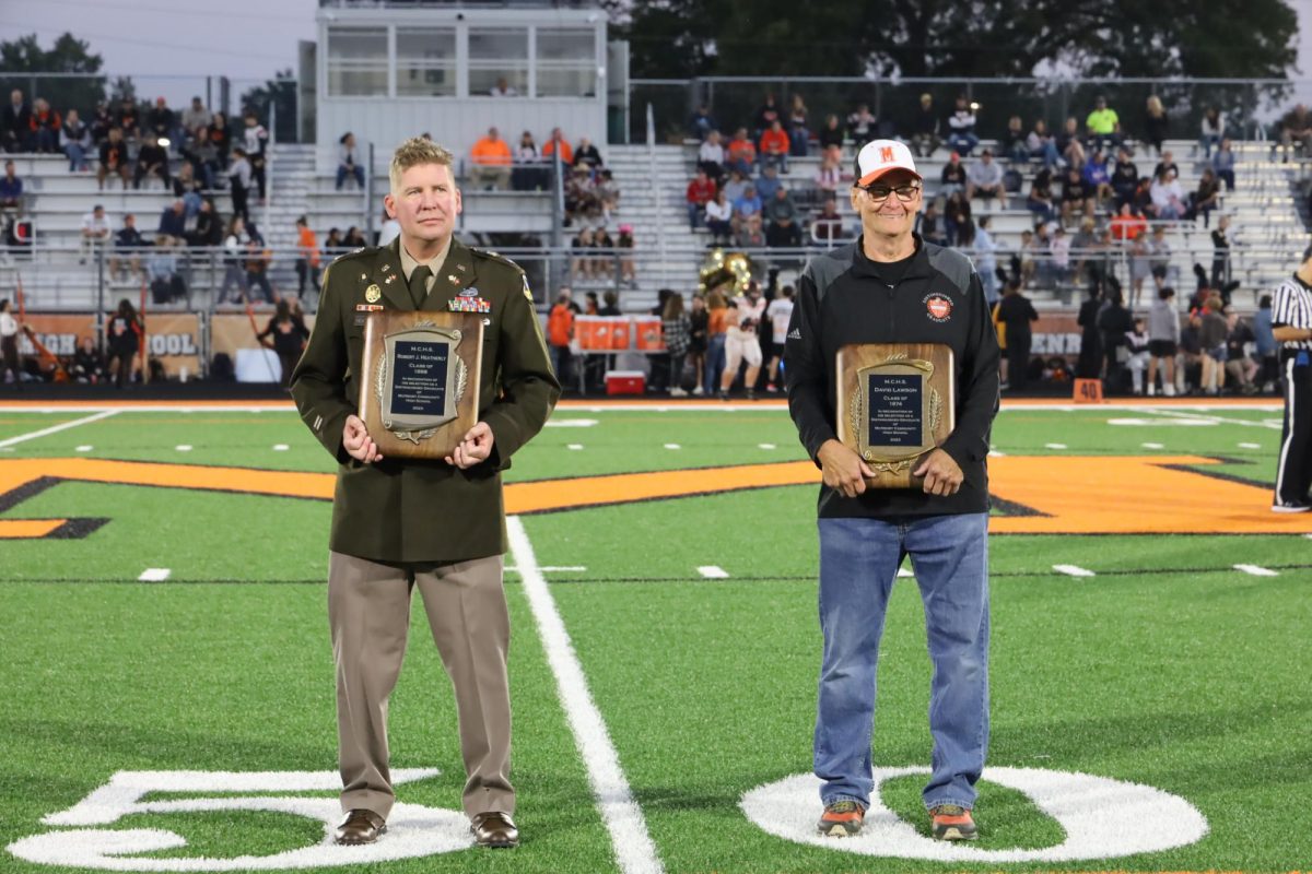 Alumni Col. Robert Heatherly and Dave Lawson are honored during the Homecoming football game on Sept. 29 at McCracken Field. Other MCHS grads were able to visit a special alumni tent during the game.
