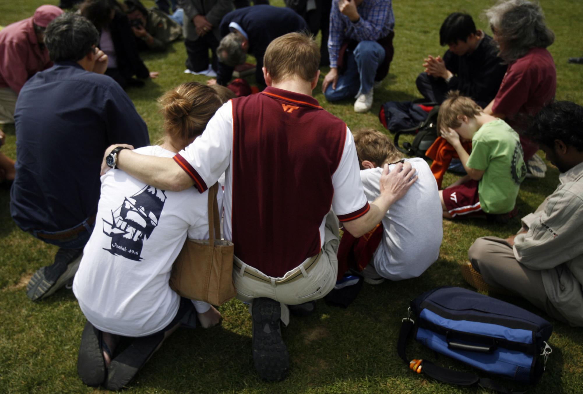 Families and students join in prayer at Virginia Techs Drill Field, Wednesday, April 18, 2007, near where more than 30 people were killed in a shooting rampage at the Blacksburg, Virginia campus on two days prior.
