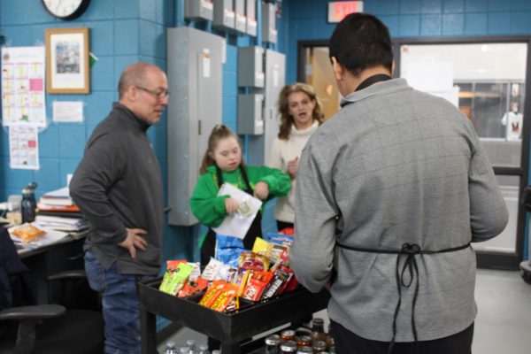 Special education teacher rolls through the halls on Friday mornings with her adjusted learning students to hand out snacks on the Treat Trolley. 