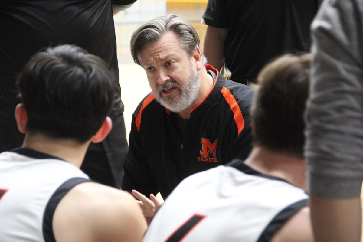 Varsity+boys+basketball+coach+Corky+Card+talks+to+the+team+during+a+time+out+on+Jan.+19+in+the+Upper+Campus+main+gym+during+a+game+against+Jacobs.