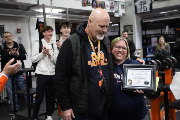 Last month, Dr. John Beerbower, physical education instructor, was awarded the 2024 Regional Coach of the Year award by the National High School Strength Coaches Association for the Great Lakes region. Students and staff congratulated him in the weightlifting room on his inspiring win.